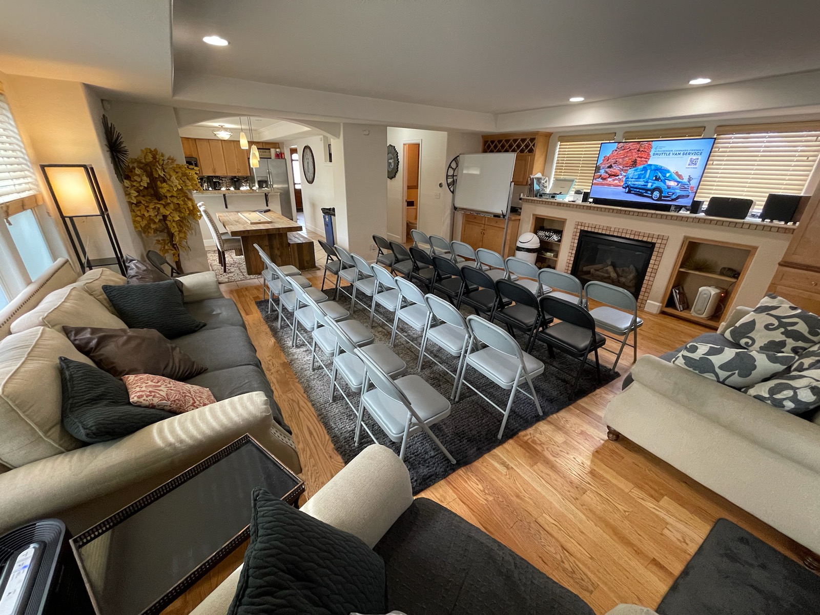 RiNo Party Palace living room set up with rows of chairs facing a TV for a team presentation